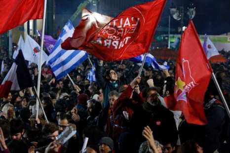 Supporters of radical leftist Syriza party chant slogans and wave Greek national and other flags after winning elections in Athens